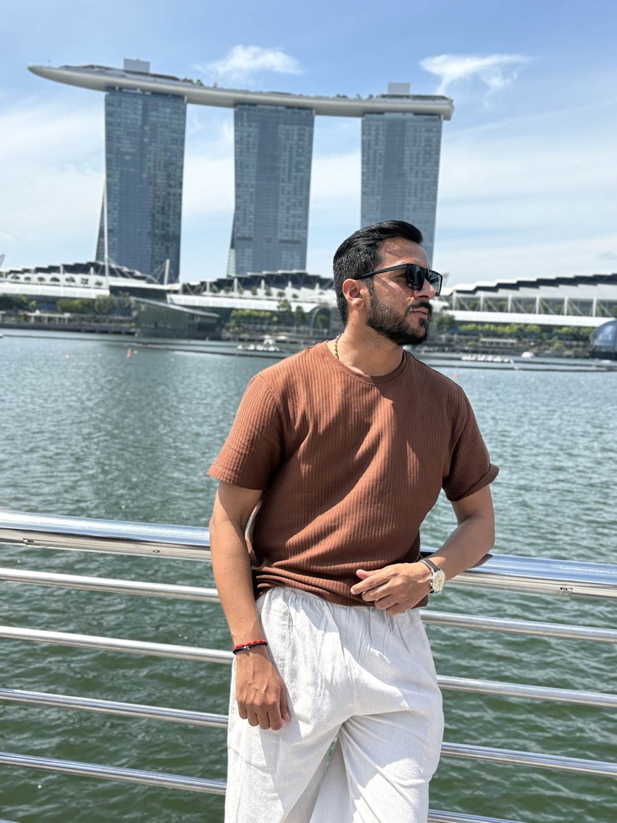 Pratik at the waterfront with Marina Bay Sands behind, Singapore
